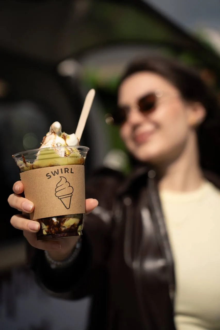 Customer smiling with a Swirl sundae cup