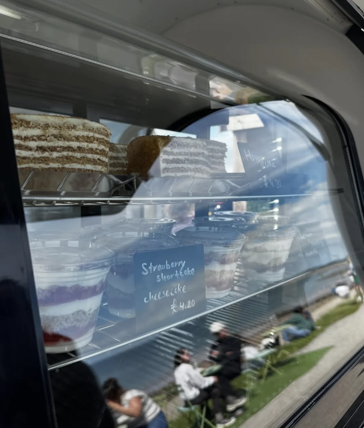 Cakes and cheesecake cups in the trailer display case