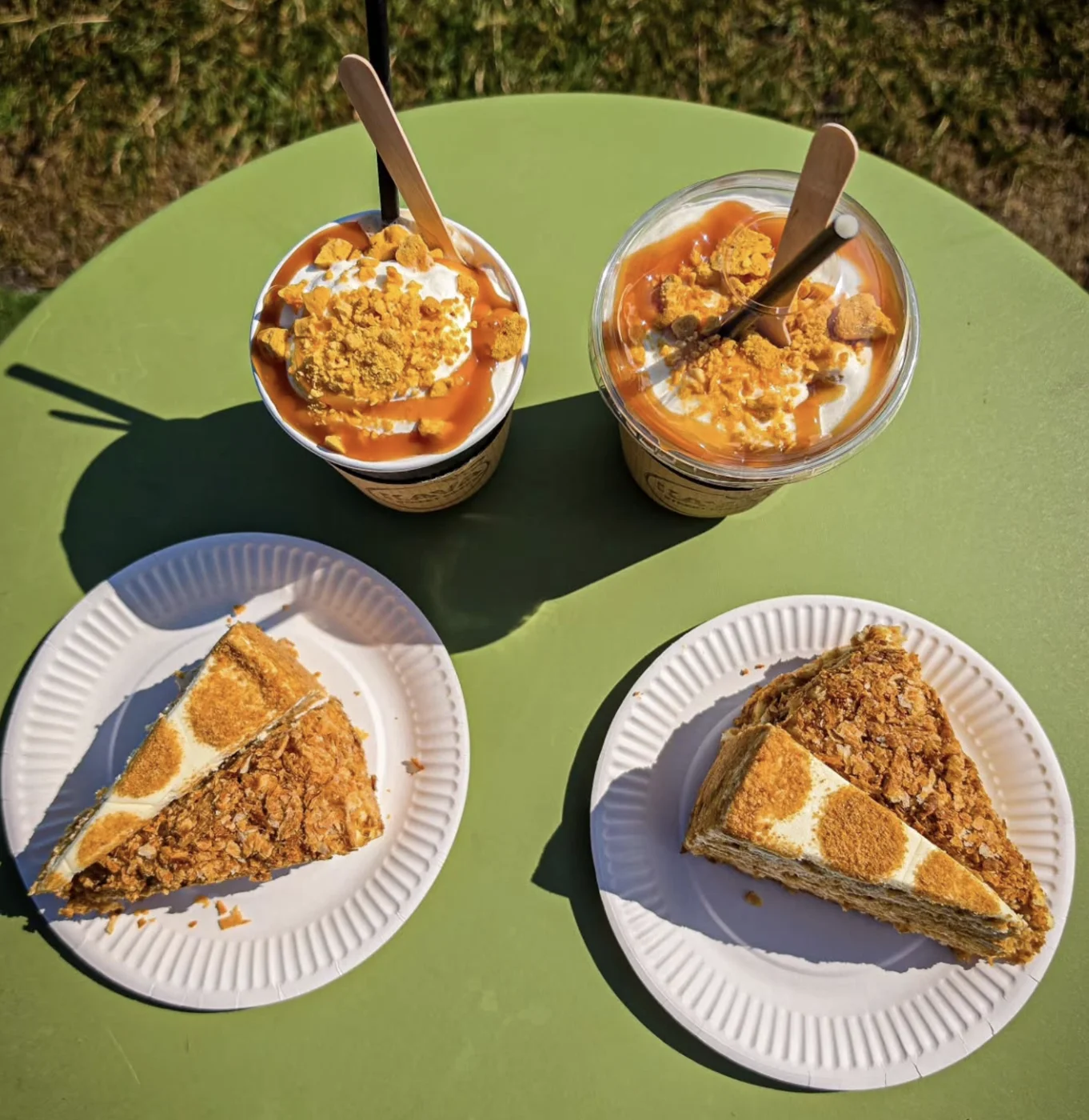 Sundaes and cake slices on a table in the sunshine