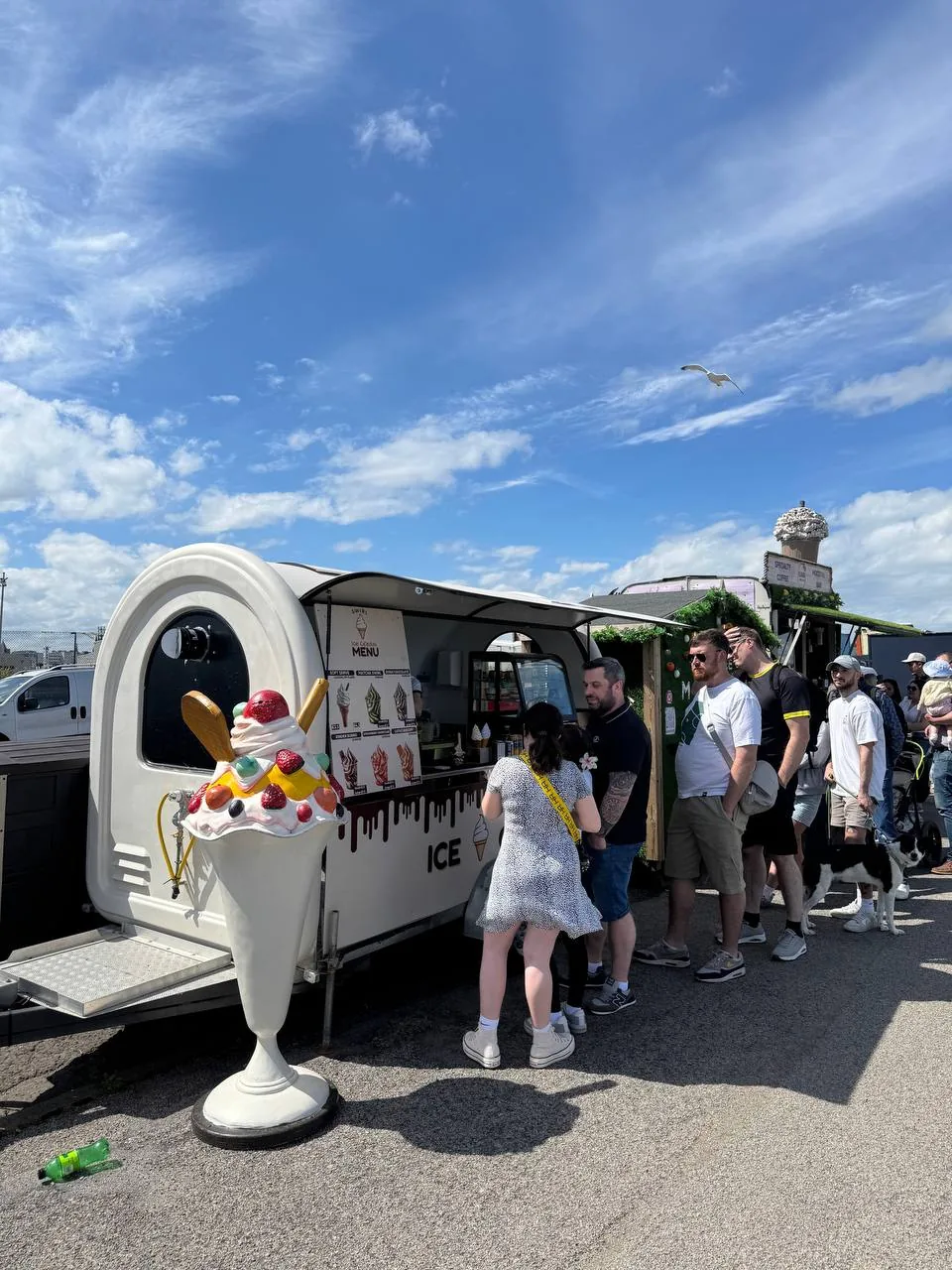 Customers queuing at the Swirl trailer on a sunny day